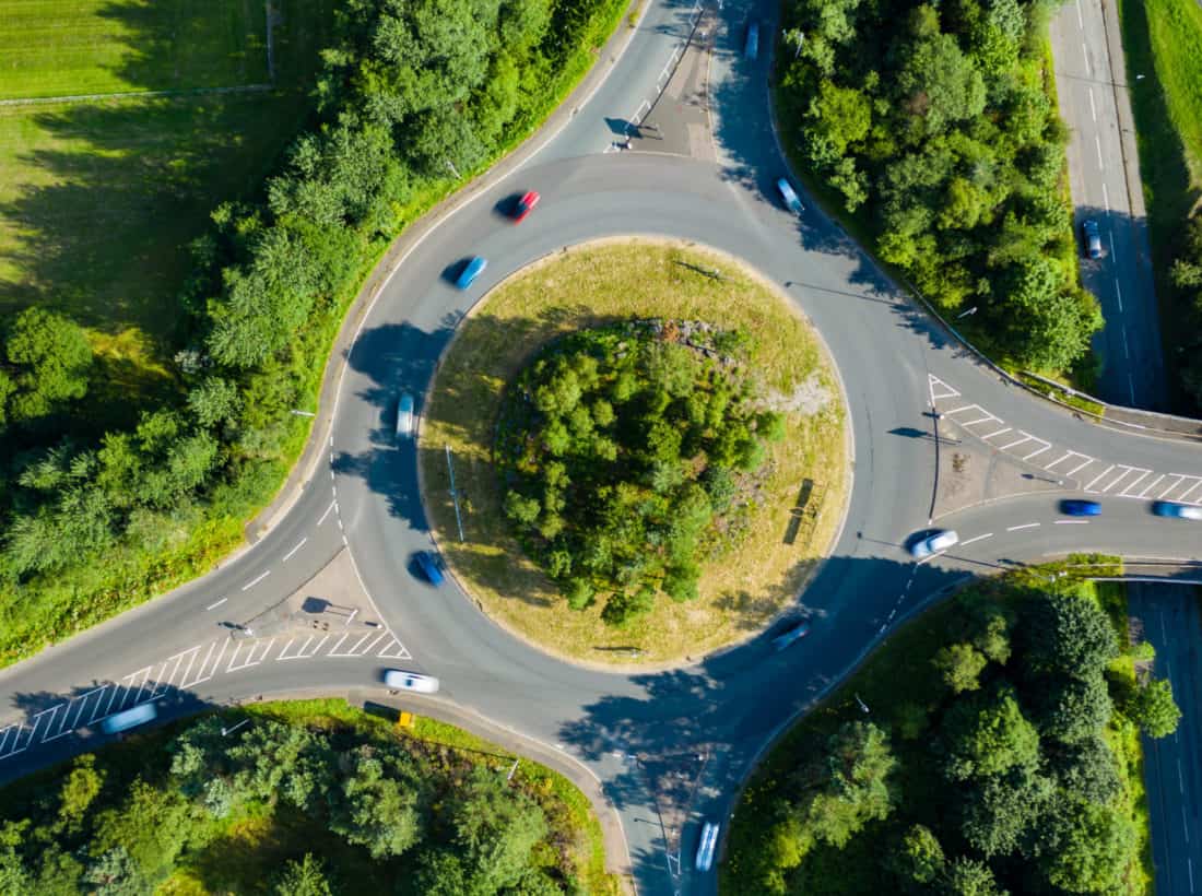 Aerial Long Exposure Of Traffic On A Roundabout In A Small Town