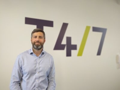 Toby Savage in front of T47 sign